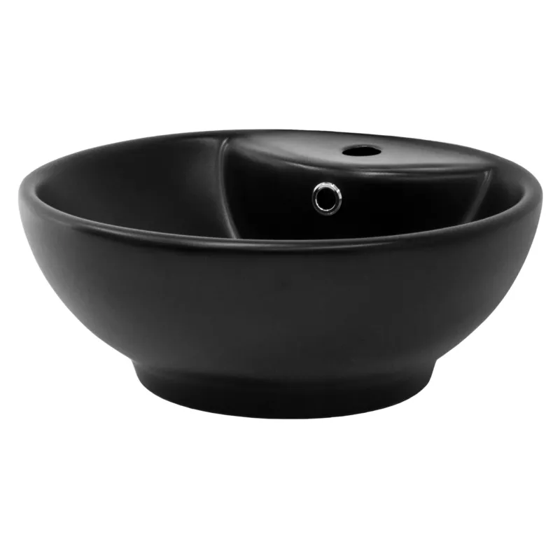 Schwarze, runde Waschschüssel mit einem kleinen Loch für den Wasserablauf.